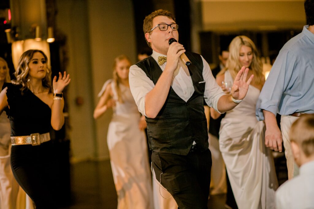 Man singing with microphone on the dance floor at The Lyric Oxford
